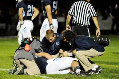 Injured Athlete Receiving Treatment on Football Field